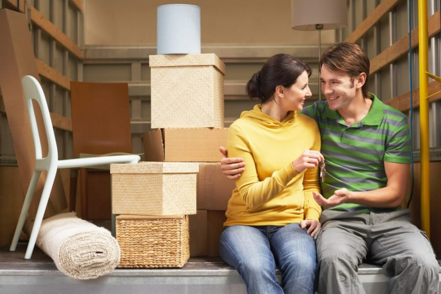 a couple packing to move to their first house